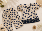 Children's floral outfit with top and pants on a light background