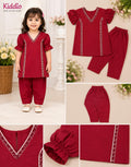 A toddler girl wearing a two-piece maroon red outfit with flutter sleeves and embroidered trim, shown in a lifestyle collage with close-up detail shots of the top, pants, and embroidery.