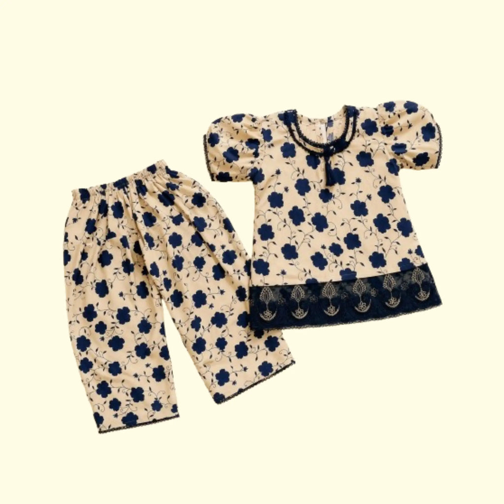 A two-piece baby clothing set featuring a short-sleeve top and matching pants in a beige fabric with a navy blue floral print, displayed on a solid cream background.